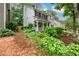 Charming two-story home with a welcoming front porch and lush landscaping at 2759 Beddington Way, Suwanee, GA 30024
