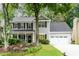 Charming two-story home with a well-manicured lawn, inviting front porch, and a two-car garage at 2759 Beddington Way, Suwanee, GA 30024