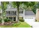 Charming two-story home with gray siding, black shutters, and a well-manicured lawn at 2759 Beddington Way, Suwanee, GA 30024