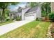 Charming two-story home with a well-manicured front lawn and attached garage at 2759 Beddington Way, Suwanee, GA 30024