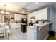 Eat-in kitchen boasts granite counters, white cabinets, and black appliances, offering a cozy space for dining at 2759 Beddington Way, Suwanee, GA 30024