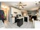 Functional kitchen with granite countertops, tile flooring, and an island, and an open view to the living room at 2759 Beddington Way, Suwanee, GA 30024