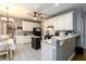 Bright kitchen offers a breakfast bar, white cabinets, stone countertops and open access to the dining area at 2759 Beddington Way, Suwanee, GA 30024