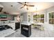 Open kitchen with granite countertops, black appliances, and eat-in dining area with natural light at 2759 Beddington Way, Suwanee, GA 30024