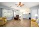 Open concept living room with hardwood floors, lots of natural light, and neutral wall paint at 2759 Beddington Way, Suwanee, GA 30024