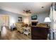 Open living room with hardwood floors, fireplace, ceiling fan and French doors to the office at 2759 Beddington Way, Suwanee, GA 30024