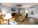 Living room features a fireplace, ceiling fan, hardwood floors, and natural light at 2759 Beddington Way, Suwanee, GA 30024