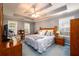 Spacious main bedroom boasts a tray ceiling, windows, and a neutral color scheme at 2759 Beddington Way, Suwanee, GA 30024
