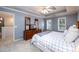 Spacious main bedroom is enhanced by a large dresser with TV and windows flanking each side at 2759 Beddington Way, Suwanee, GA 30024