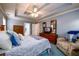 Spacious bedroom features a trey ceiling, ceiling fan and a comfy sitting area at 2759 Beddington Way, Suwanee, GA 30024