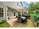 Outdoor patio with an umbrella, dining table, and lush green landscaping at 2759 Beddington Way, Suwanee, GA 30024