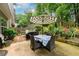 Charming patio with a dining set and lush surroundings providing a great entertaining space at 2759 Beddington Way, Suwanee, GA 30024