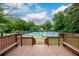 Tennis courts with covered seating accessible from wooden deck at 2759 Beddington Way, Suwanee, GA 30024