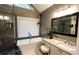 Bright bathroom features a soaking tub, a glass enclosed shower, and granite countertops at 308 Forkwood Trl, Woodstock, GA 30189