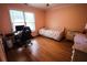 Bedroom with wood floors and a bright window at 308 Forkwood Trl, Woodstock, GA 30189
