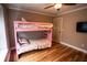 Bedroom featuring a pink bunk bed, hardwood floors, and a ceiling fan at 308 Forkwood Trl, Woodstock, GA 30189