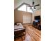 Bedroom with wood floors and a triangular window bringing in natural light at 308 Forkwood Trl, Woodstock, GA 30189