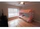 Bedroom with a pink bunk bed, hardwood floors, and a window at 308 Forkwood Trl, Woodstock, GA 30189