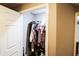 View of a small walk-in closet with rod and shelf for storage organization at 308 Forkwood Trl, Woodstock, GA 30189