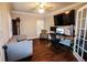 Bright home office with hardwood floors, a large screen TV, and an antique clock at 308 Forkwood Trl, Woodstock, GA 30189