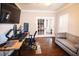 Bright home office with hardwood floors, a large screen TV, and french doors at 308 Forkwood Trl, Woodstock, GA 30189