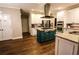 Bright kitchen featuring stainless steel appliances, gas cooktop on island, granite countertops, and gorgeous wood floors at 308 Forkwood Trl, Woodstock, GA 30189