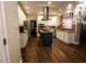 Spacious kitchen featuring stainless steel appliances, gas cooktop on island, granite countertops, and sleek hardwood floors at 308 Forkwood Trl, Woodstock, GA 30189