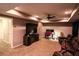 Finished basement living room with TV, ceiling fan, and comfortable seating at 308 Forkwood Trl, Woodstock, GA 30189
