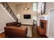 Living room features a brick fireplace, hardwood floors, and a staircase at 308 Forkwood Trl, Woodstock, GA 30189