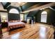 Spacious primary bedroom with hardwood floors, vaulted ceiling, and lots of natural light at 308 Forkwood Trl, Woodstock, GA 30189