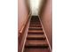 Carpeted staircase with wooden handrail leading up to a white door at 308 Forkwood Trl, Woodstock, GA 30189