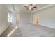 Spacious bedroom featuring neutral carpet, a ceiling fan, and ample natural light at 327 Tulip Dr, Covington, GA 30016