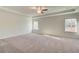 A very large main bedroom with neutral paint and carpet and a tray ceiling at 327 Tulip Dr, Covington, GA 30016