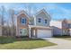 Beautiful two-story home with a brick and siding exterior, featuring a spacious two-car garage and a green lawn at 327 Tulip Dr, Covington, GA 30016