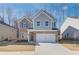 Charming two-story home featuring a brick facade and a two-car garage, perfect for suburban living at 327 Tulip Dr, Covington, GA 30016