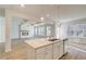 Modern kitchen with a center island, stainless steel appliances, and a view to the living area at 327 Tulip Dr, Covington, GA 30016