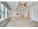 Open-concept living space with coffered ceilings, a modern kitchen, and lots of natural light at 327 Tulip Dr, Covington, GA 30016