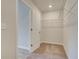 Walk-in closet with shelving and carpeted floor at 327 Tulip Dr, Covington, GA 30016