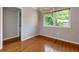 Dining room with hardwood floors, chandelier, large window, and neutral wall color at 100 Biscayne Nw Dr # D7, Atlanta, GA 30309