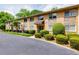 Apartment building featuring brick facade, stone accents, manicured landscaping, and asphalt driveway at 100 Biscayne Nw Dr # D7, Atlanta, GA 30309