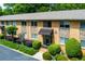 Attractive apartment building featuring brick and stone accents, manicured landscaping and covered entryway at 100 Biscayne Nw Dr # D7, Atlanta, GA 30309