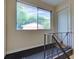 Hallway showing stairs with metal railings and a view through a window; unit entrance door at 100 Biscayne Nw Dr # D7, Atlanta, GA 30309