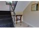 Hallway with black carpet stairs, a small decorative table with tiled floors, and neutral colored walls at 100 Biscayne Nw Dr # D7, Atlanta, GA 30309