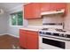 Vintage kitchen featuring red cabinets, laminate countertops, and a retro stove at 100 Biscayne Nw Dr # D7, Atlanta, GA 30309