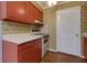 Cozy kitchen featuring red cabinets and classic appliances with a white range and countertops at 100 Biscayne Nw Dr # D7, Atlanta, GA 30309