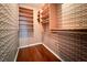Walk-in closet featuring geometric wallpaper and wooden shelving on both sides at 100 Biscayne Nw Dr # D7, Atlanta, GA 30309