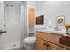 Well-lit bathroom featuring a shower, toilet, sink vanity, and wooden cabinet for extra storage at 1127 Riverbend Club Se Dr, Atlanta, GA 30339