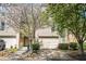 Charming townhome with flowering tree, attached garage, and inviting entrance at 1127 Riverbend Club Se Dr, Atlanta, GA 30339