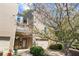 Inviting townhome featuring an attached garage and flowering tree at 1127 Riverbend Club Se Dr, Atlanta, GA 30339