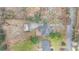 Aerial view reveals the home's roof, deck, driveway, and lush tree-filled surroundings at 2044 Wilandrew Dr, Decatur, GA 30033